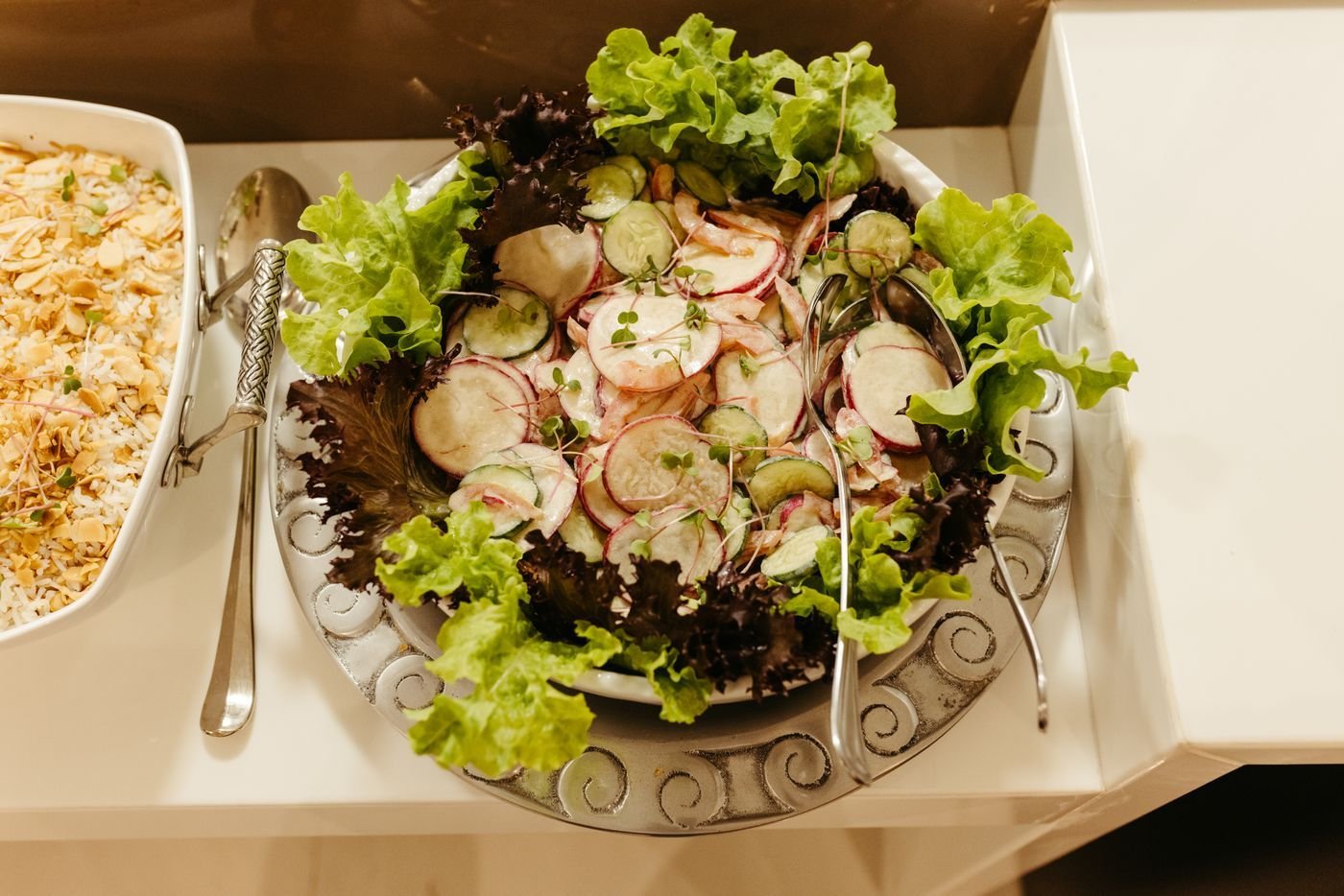 Radish, cucumber and lettuce salad in a silver bowl