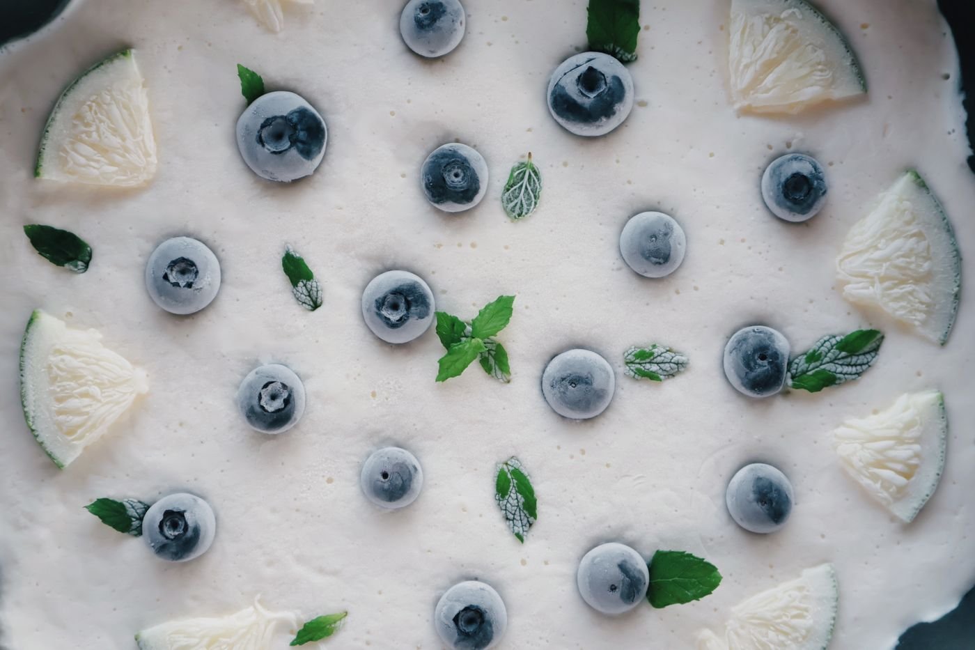 Coconut ice slab set with blueberries, lime wedges and mint