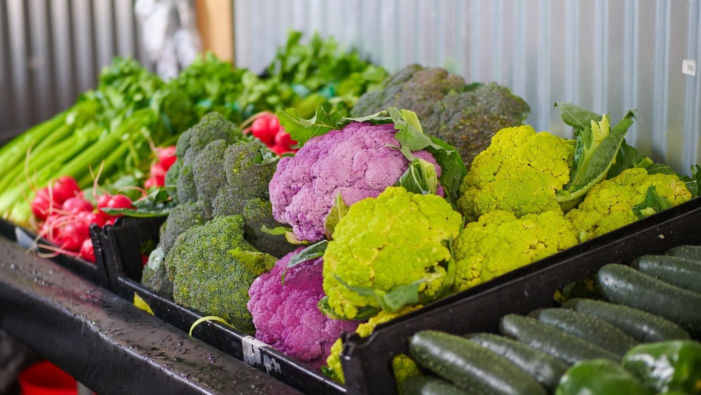 Purple, green and white cauliflower with broccoli at a market